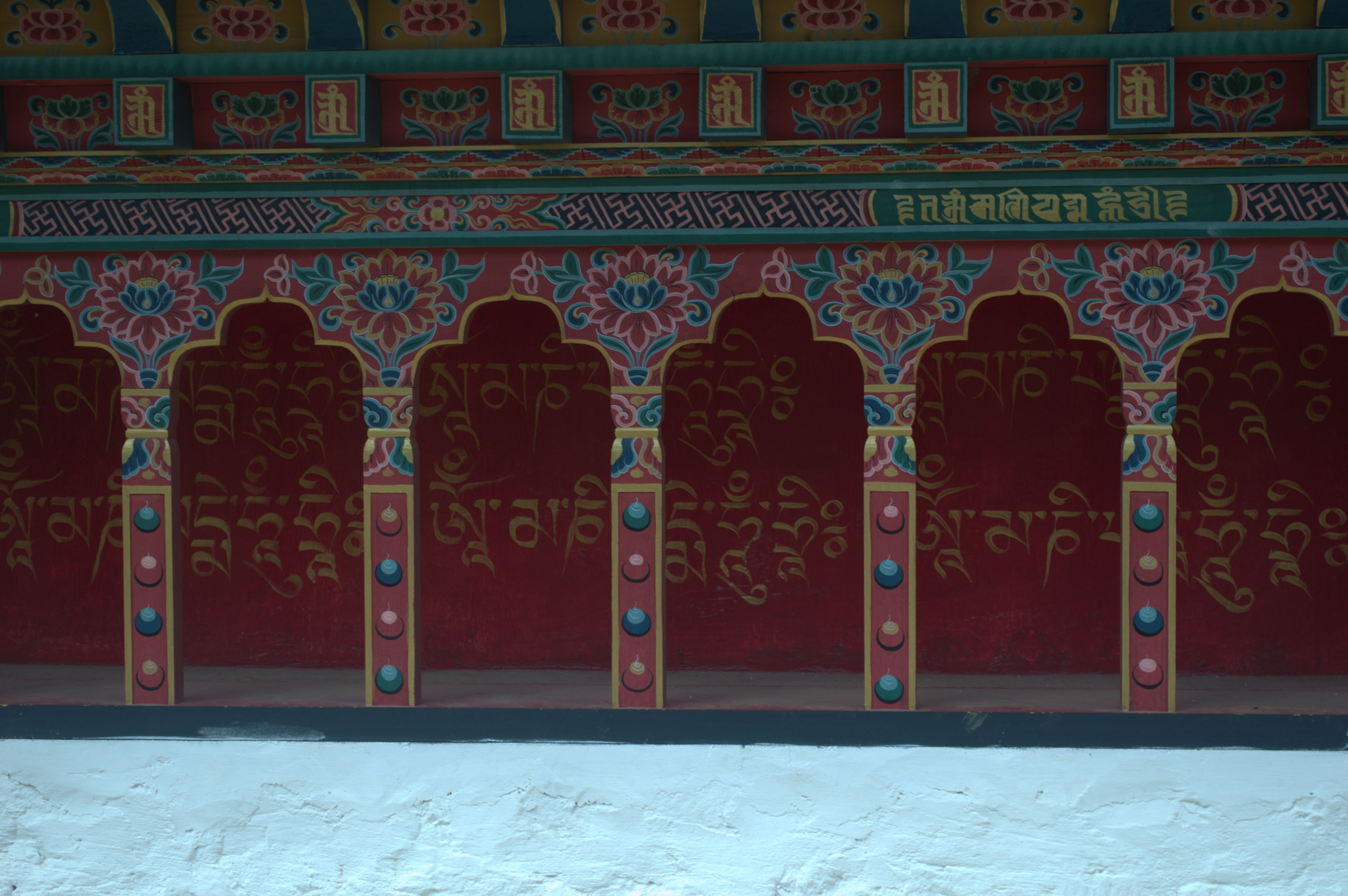 Om Mani Padme Hum mantra is written on the wall inside the window.